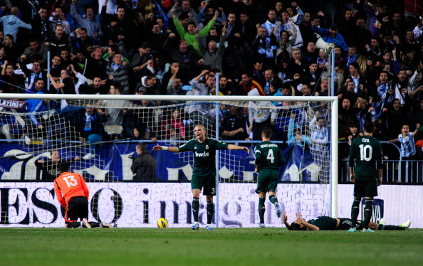 MALAGA, SPAIN - DECEMBER 22:  Real Madrid CF players react dejected after Francisco R. Alarc?n Isco of Malaga CF scored the opening goal during the La Liga match between Malaga CF and Real Madrid CF at La Rosaleda Stadium on December 22, 2012 in Malaga, Spain.  (Photo by David Ramos/Getty Images)